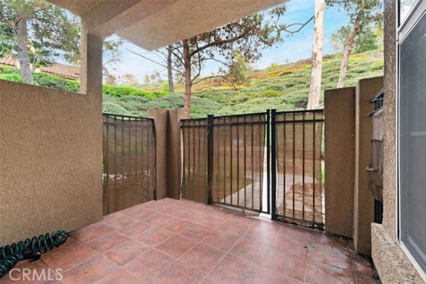 Looking out from the tiled, covered patio emphasizes the privacy of this location.