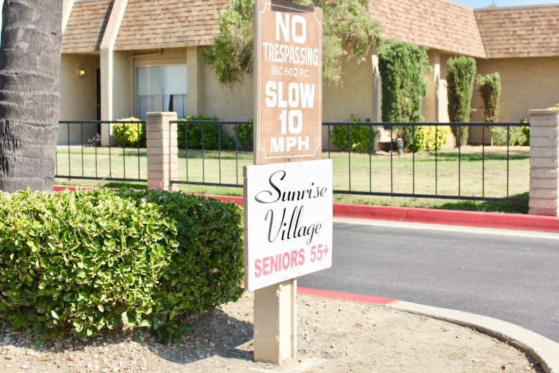 A "No Trespassing" sign sits above a sign for a community at the Sunrise Village.