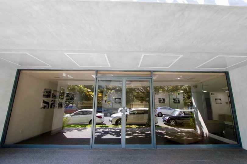 cars parked outside a large building in California