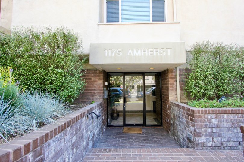 Nicely landscaped brick entry door to Amherst Community in Brentwood california