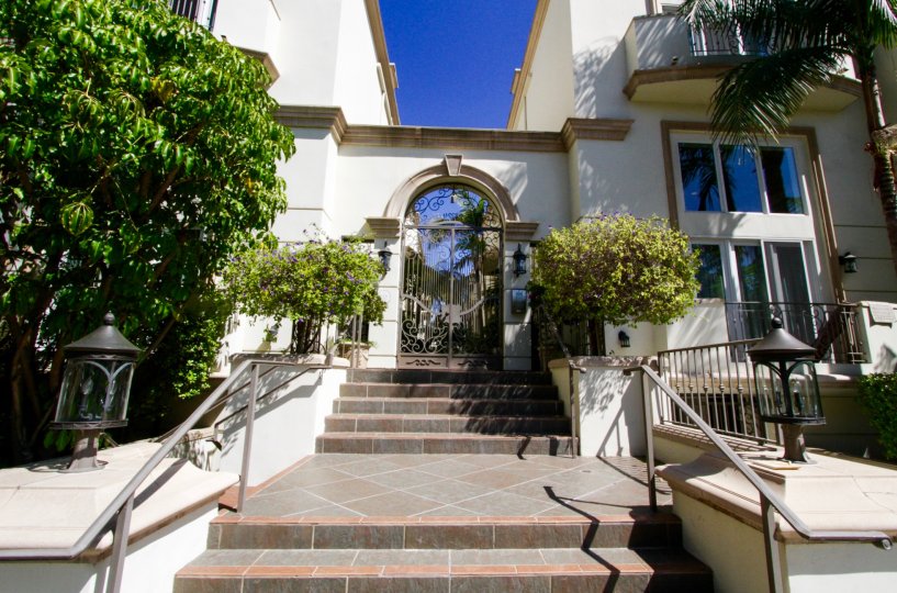 Up a flight of stairs to the gated entrance of Mayfield Gardens condos