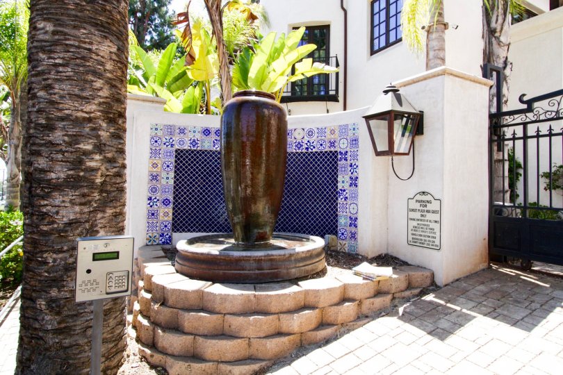 A vase fountain at the gated entry to Villas Del Encanto