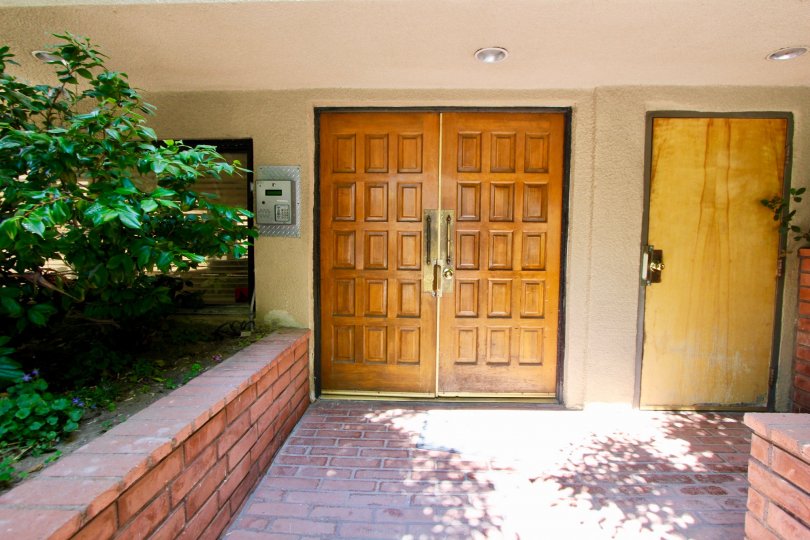 Sturdy paneled double wood doors and brick walkway to entry at Concept 84 in Brentwood California