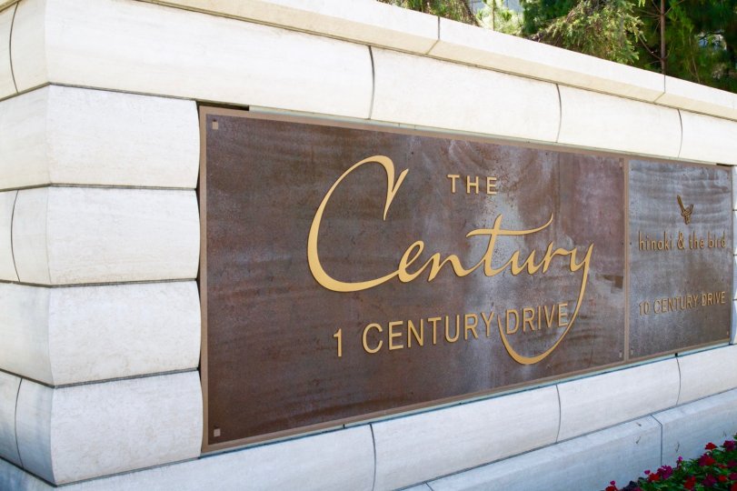 The Century marquee written in gold lettering on a metal plaque