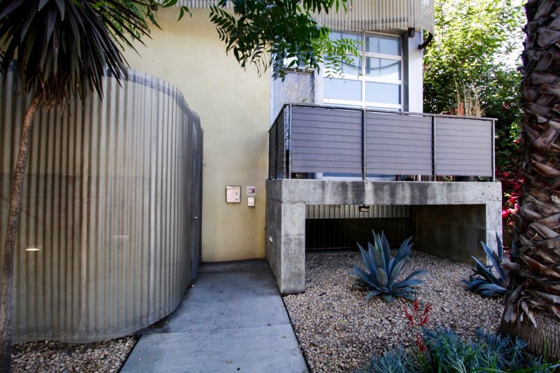 A curved metal fence leads to the front entrance of Gordon Lofts
