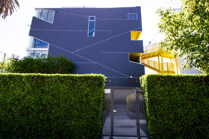 WA Lofts is a modern condo building comprised of dark grey stucco and a bright yellow exterior staircase