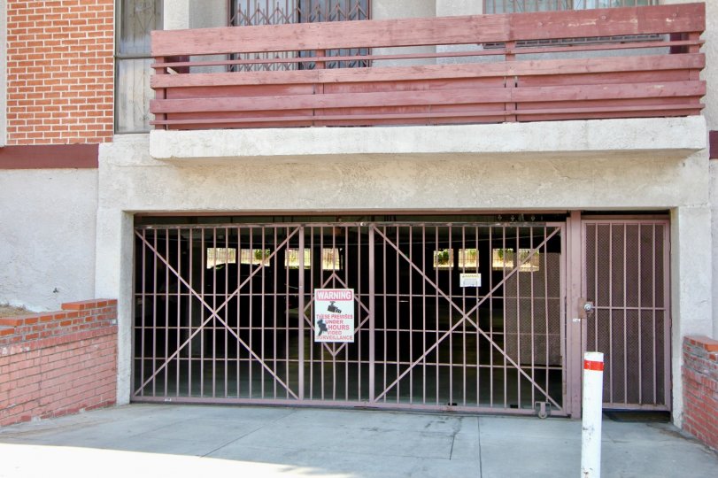 Parking entrance gate to Lucky Mansion brick building
