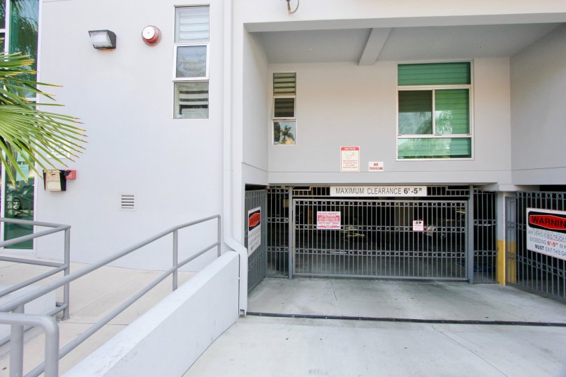 Oxford Plaza parking entrance gate with ADA ramp to building entrance