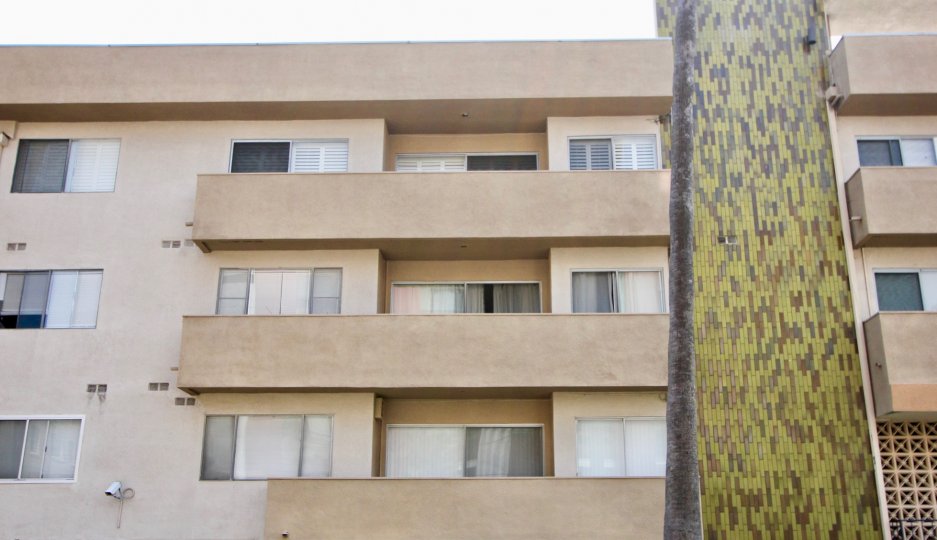 Daytime view of windows and balconies of many different homes in the San Marcus community
