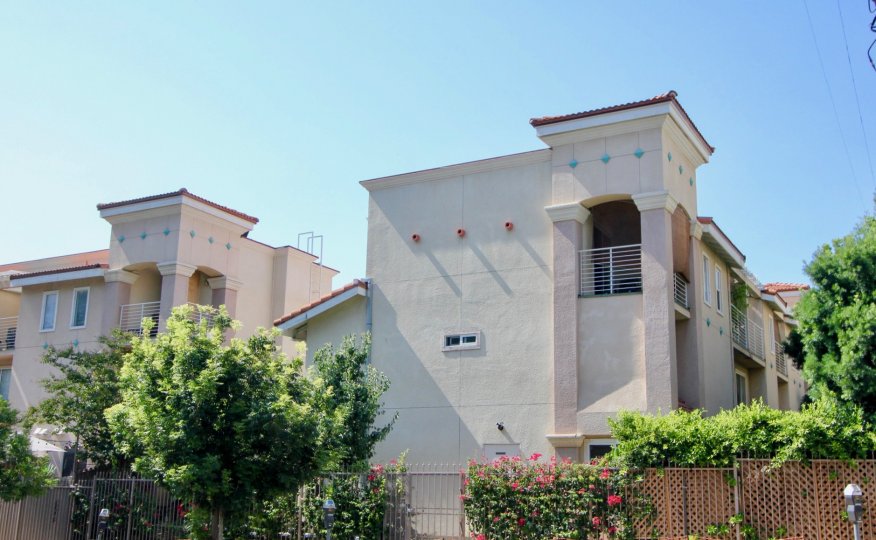 The Villas with personal terraces at Shatto VIllas with fencing, rose bushes and trees.