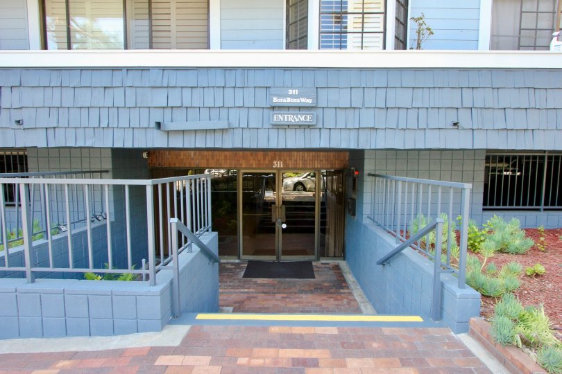 The steps leading down to the entrance of the blue building at 311 Via Marina Tahiti, Marina del Rey, California
