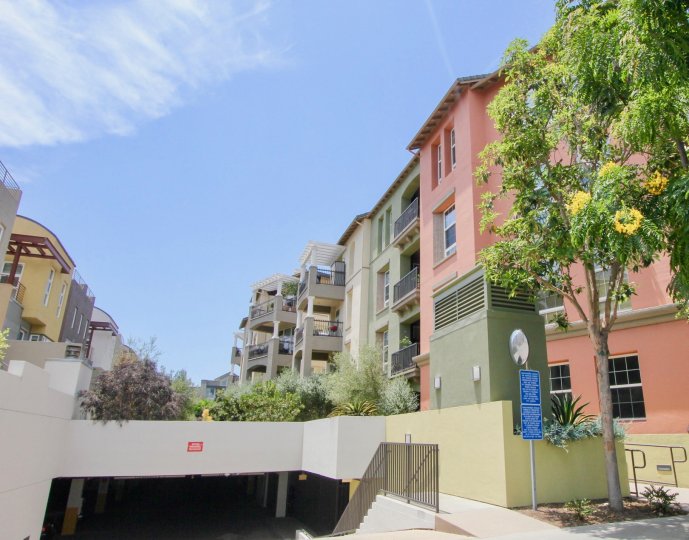 The bright facades and parking deck entrance of The Lofts at Playa Vista.