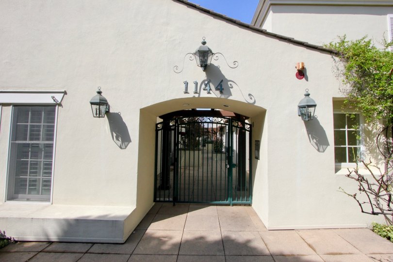 Entrance to 1144 Yale St with lanterns on either side on a sunny day.