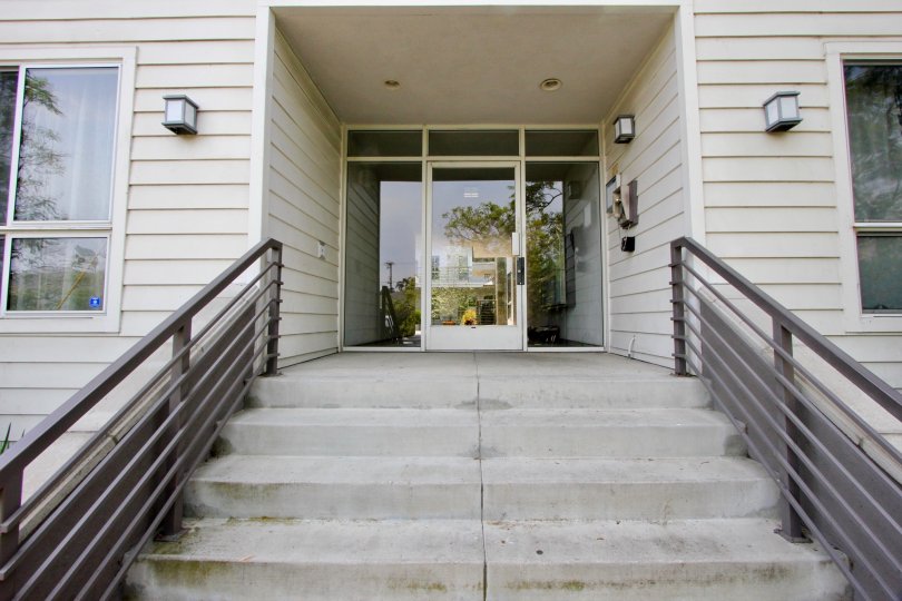 A staircase leading to an entrance with wooden cladding to the 832 Euclid community.