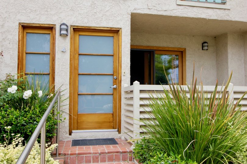 The closed front door of Bay Blue Vista with small plants in front side