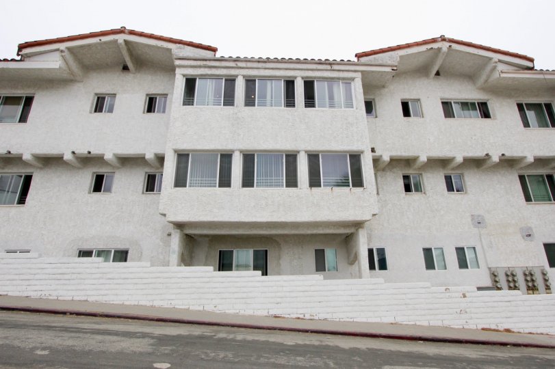 The Ocean View Santa Monica building looks tall with many open glass windows