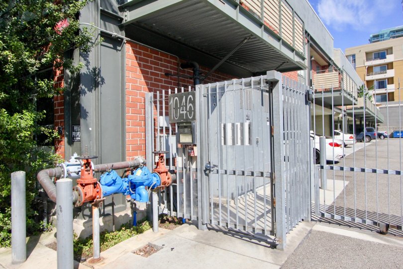 Gated entrance next to water monitor at the Silicon Beach Lofts in Venice