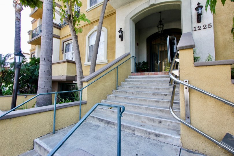 Entrance to building with stairs and palm trees in West La California
