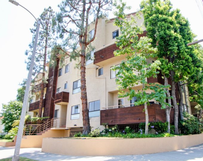 Large wooded balconies with decorative trees and flower gardens among curbdrive
