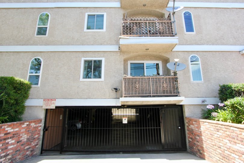 Covered balcony and gated parking garage loated in Colonial Regency in West LA