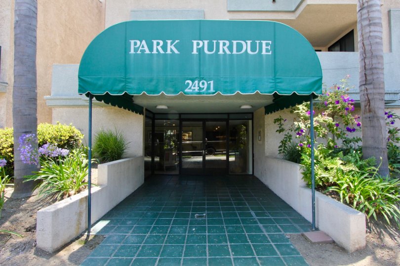Floral landscaping and covered entrance to the Park Purdue in West LA