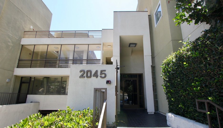 Well cut and decorated plants and flowers in front of a Cream Colored Office Building at The Pines in West LA California with house number 2045