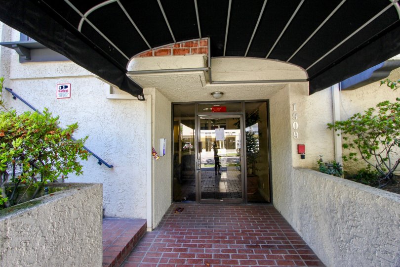 The brick paved entrance under a black awning at Glendon Terrace II.