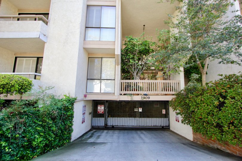 View of apartments with gated entrance; balconies.