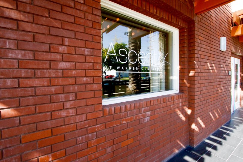 The name of Ascent At Warner Center on the window