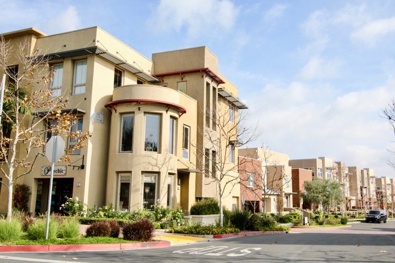 A SIGHT OF A COLONY WITH CREAM & RED COLOURED APARTEMENTS LOCATED BY THE ROAD SIDE