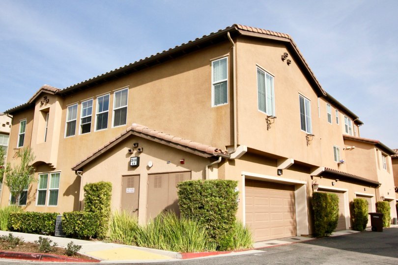 A BEAUTIFUL LIGHT BROWN COLOURED BUILDING WITH SOME GREENERY AND HUGE FREE SPACE