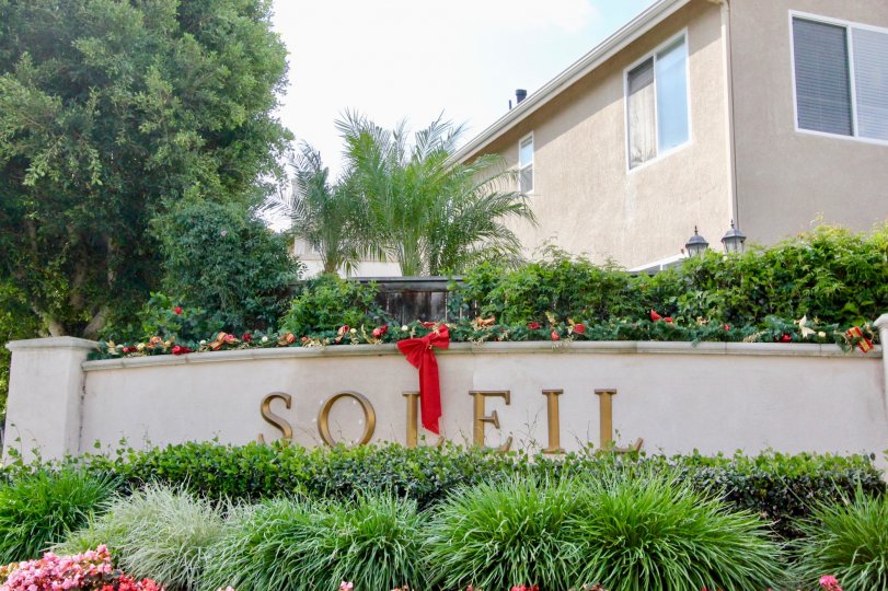 The Soleil neighborhood welcomes guests with their stone sign, decorated for the holiday season.