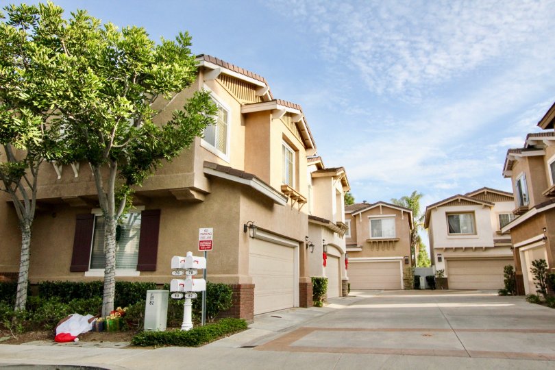 Sunny sky with apartments and garages and trees in the Vista Heights Community in Aliso Viejo, CA.