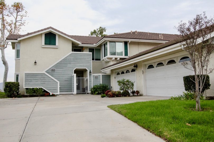 THE HOUSE IN THE CANYON POINTE WITH THE LAWN, PLANTS, TREES