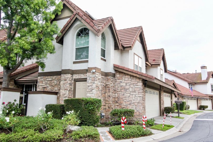 A row of two story homes with brick first floors and dry wall second floors at Royal Court Village in Anaheim Hills CA