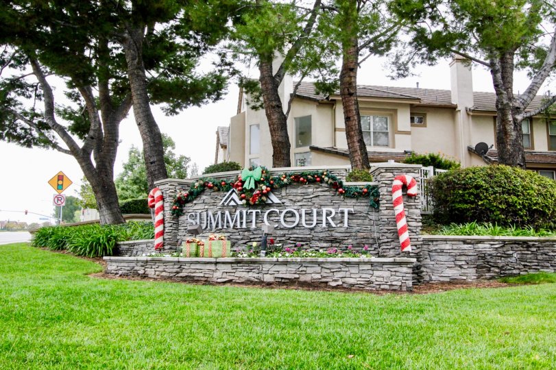 The view of the Summit Court community sign decorated for the Christmas season.