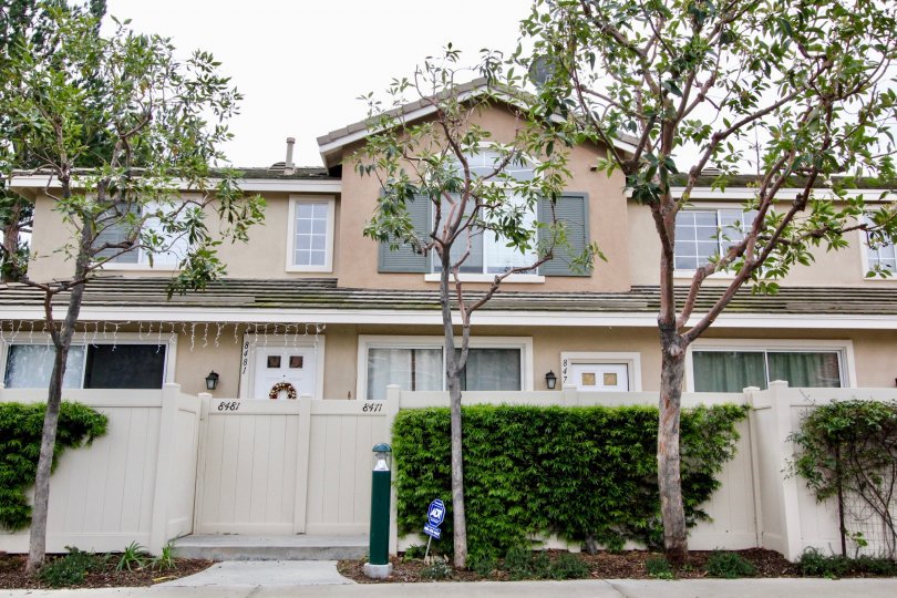 THE FRONT VIEW OF HOUSE CLOSED WITH DOOR, SHOWS GLASS WINDOWS, TREES, PLANTS ARE THERE IN THE COMMUNITY OF SUMMIT PARK