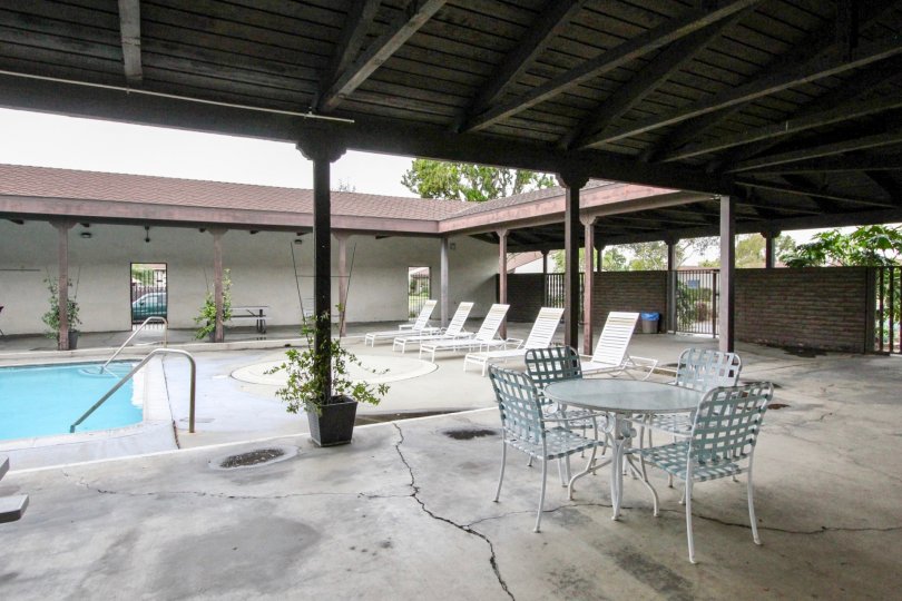 A covered seating area in the pool of the Casa Emperador community.
