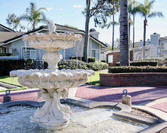 Near the houses in Stanford Court has tall trees and fountain with cutted bushes