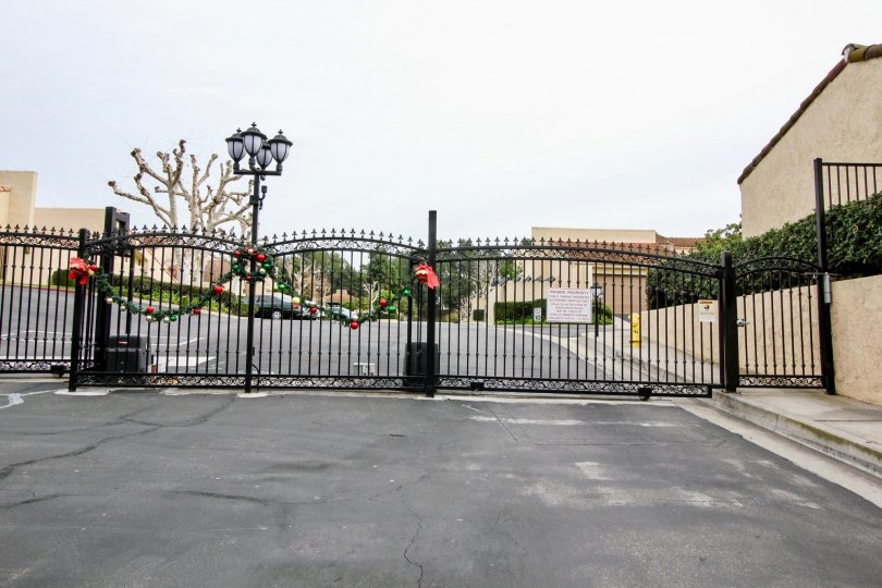 a rainy day in the buena tierra with a building that has lamp light in front and entrance gate closed