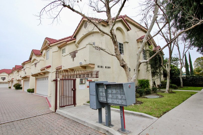 THIS IS THE ENTRANCE WAY TO THE APARTMENT LOCATED IN BUENA PARK, ON THE FRONT LAWN, TREES ARE THERE