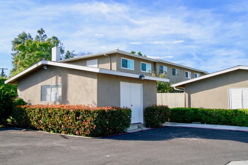 THE HOUSE LOCATED WITH BEAUTIFUL LOOK AND IT REPRESENT GRAY COLOR AND SOME GARDENS ARE NEAR TO THE HOUSE AT THE MORNING TIME.