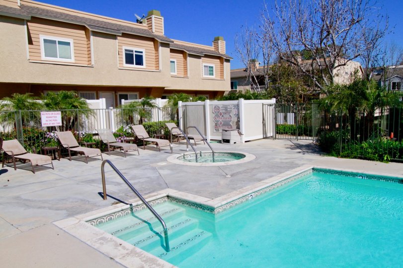 The house in the Ocean Breeze Villas is like a restaurant and also with swimmingpool with chairs and plants, trees.