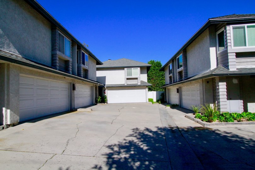 Pelican Point street with two story apartments on either side on a sunny day,