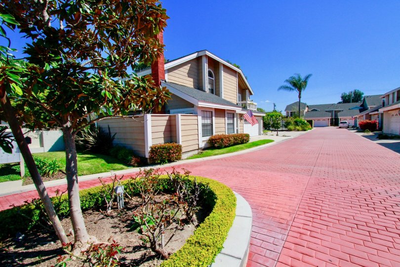 Spinnaker Cove Costa Mesa the tree in front is very colourful and the platform is in brick design