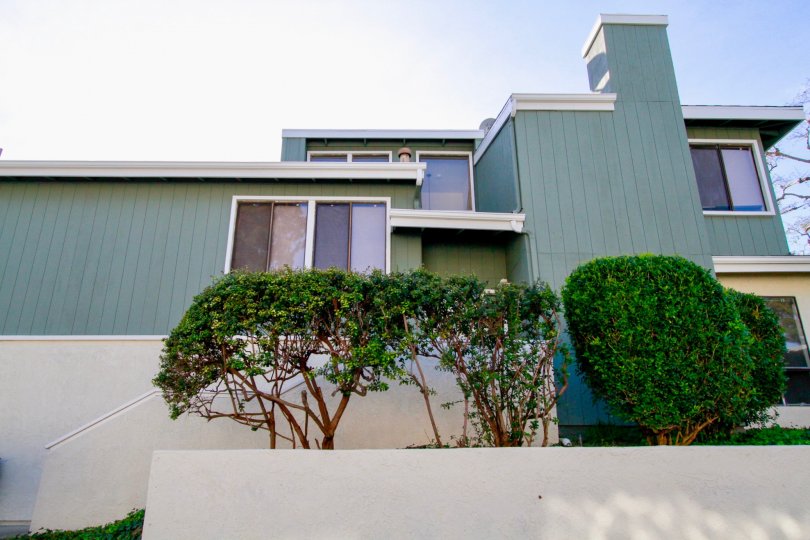 A turquoise home with well kept trees in Village Creek, Costa Mesa, Ca.