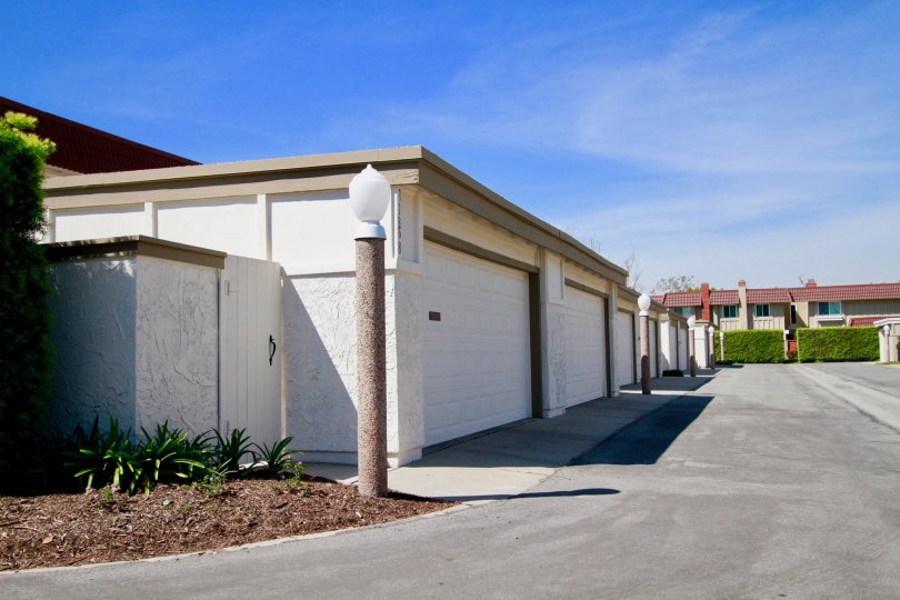 A row of garages and a building in the Cypress Village community on a sunny day