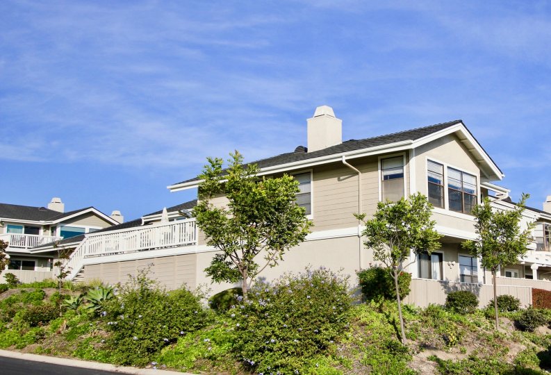 a sunny day in the sea ridge with house that has glass winow and garden around