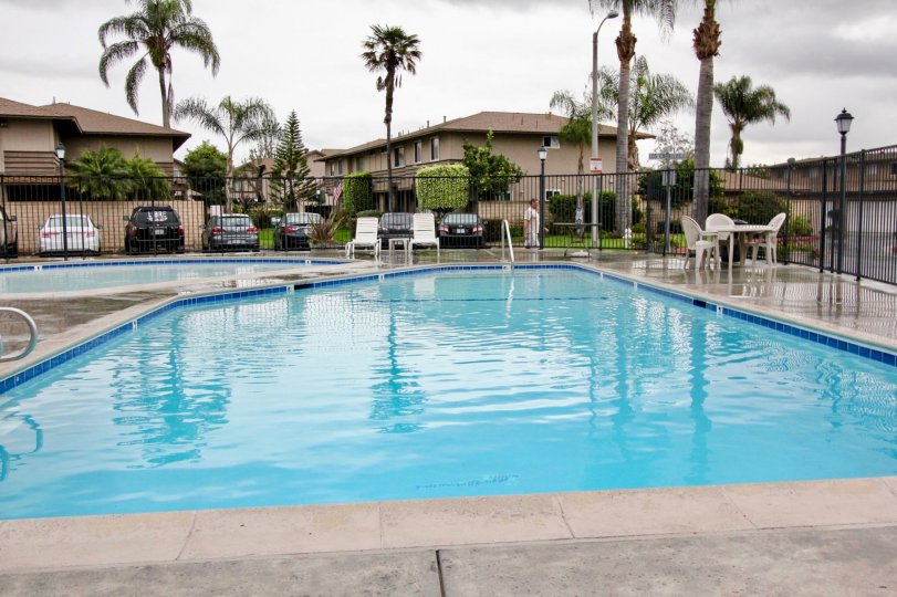 The sunny day in the Fountain Plaza with swimming pool and chairs.