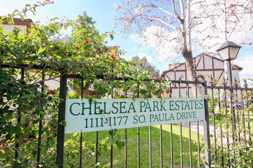 A metal fence with the community name Chelsea Park estates on it.